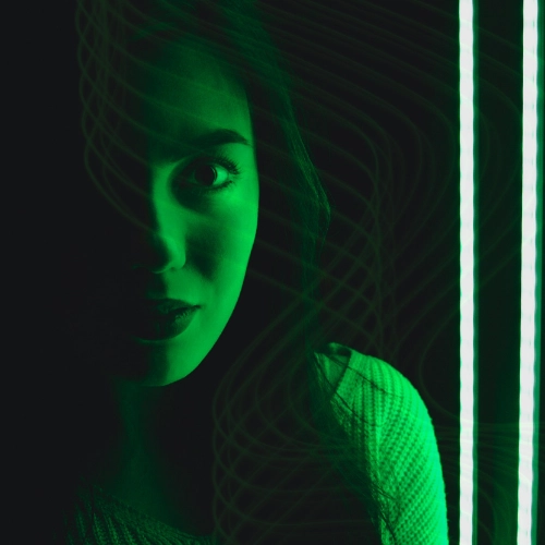 a woman shrouded by green light