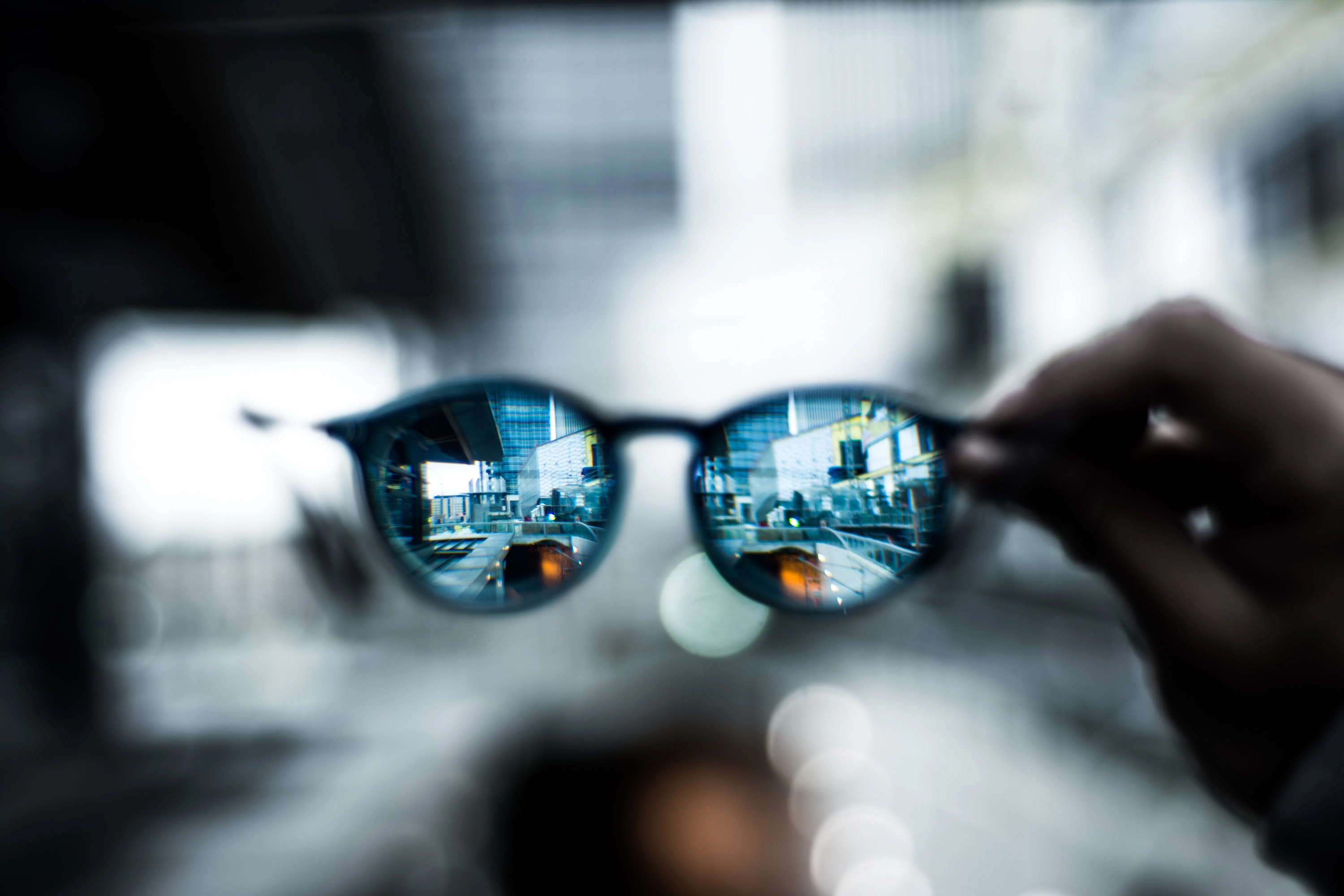 glasses zoomed in to a cityscape