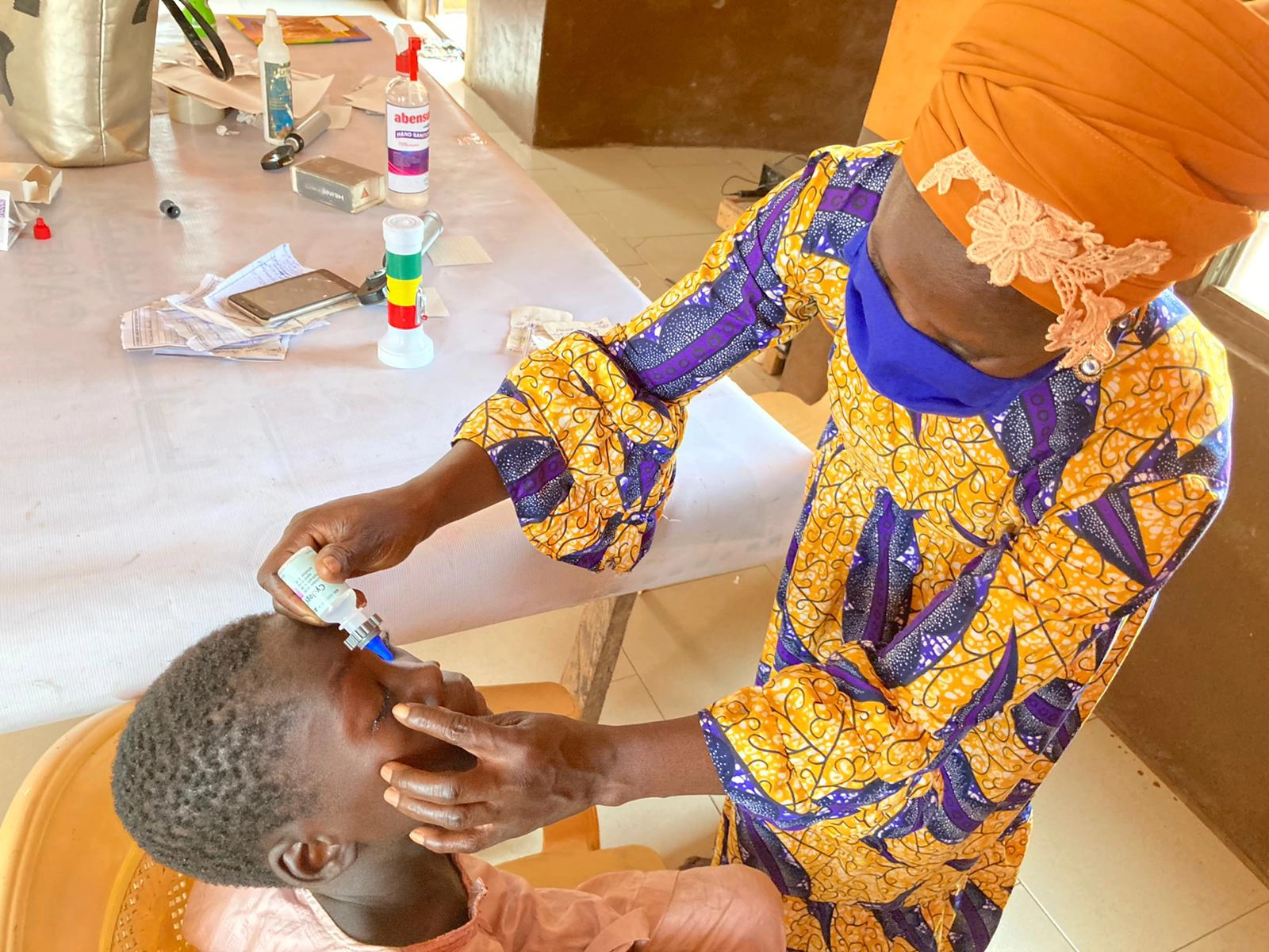 a patient receiving an eyedrop with the nanodropper